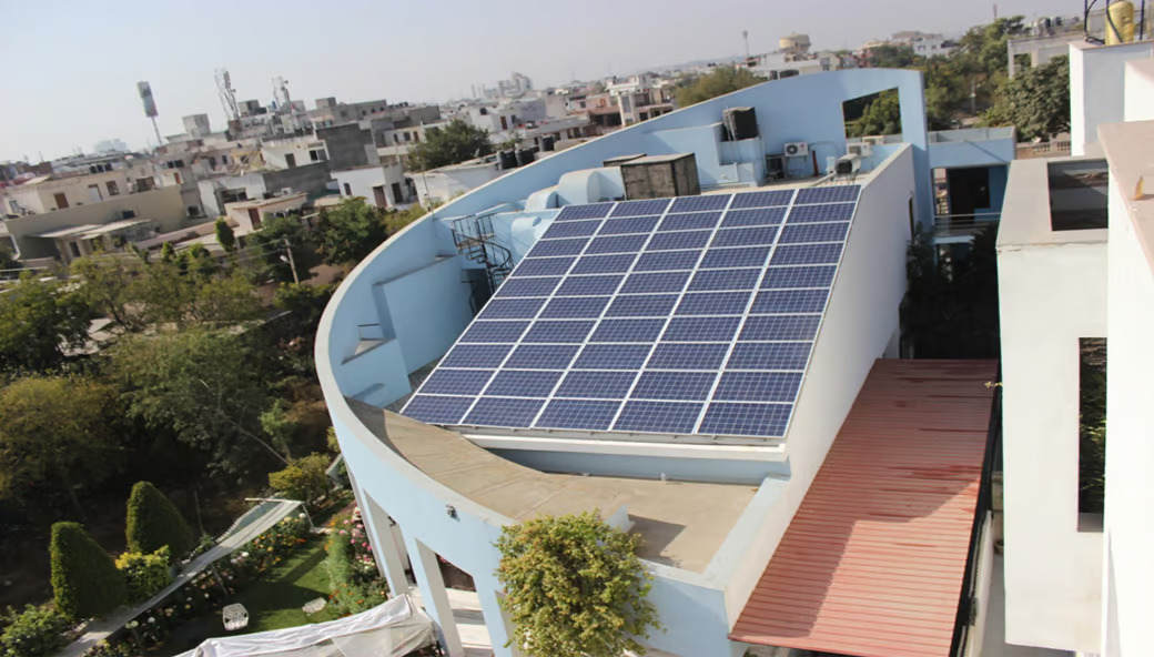 Solar panels installed on the roof of a house located in Jaipur, Rajasthan, highlighting eco-friendly living.